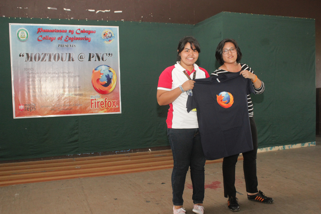 Monique hands over a Firefox shirt to the lucky student