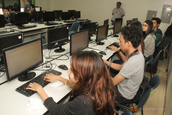 Some of the participants trying out the code flashed in the big screen.