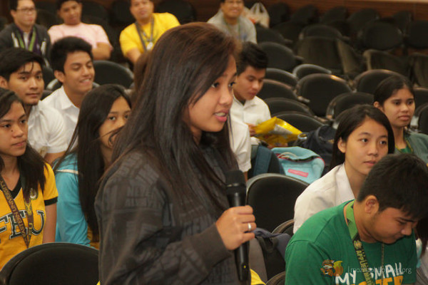 A student asking a question to the speakers